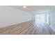 A generous living room space featuring wood flooring and fan at 256 Cypress Ln # 120, Oldsmar, FL 34677