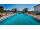 Inviting community pool with clear blue water and plenty of lounge seating at 256 Cypress Ln # 120, Oldsmar, FL 34677