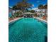 Community pool with people enjoying the water on a sunny day at 256 Cypress Ln # 120, Oldsmar, FL 34677