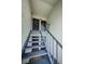 Exterior staircase leading to upper-level condo units in a multi-Gathering building with metal banisters and outdoor access at 256 Cypress Ln # 120, Oldsmar, FL 34677