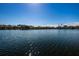 Expansive water view with serene lake reflecting the clear blue sky, enhanced by bright sunlight at 256 Cypress Ln # 120, Oldsmar, FL 34677