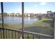 Screened balcony view overlooking a serene lake and landscaped grounds of the community at 256 Cypress Ln # 120, Oldsmar, FL 34677