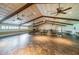 Spacious banquet room featuring rustic ceiling beams, neutral walls, and vinyl flooring at 2731 Sherbrooke Ln # D, Palm Harbor, FL 34684