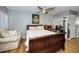 Comfortable bedroom with a wooden bed frame and a sitting area at 2731 Sherbrooke Ln # D, Palm Harbor, FL 34684