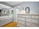 Bedroom with a dresser and access to the bathroom area at 2731 Sherbrooke Ln # D, Palm Harbor, FL 34684