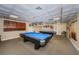 Relaxing billiard room with two pool tables, overhead lighting, and comfortable seating at 2731 Sherbrooke Ln # D, Palm Harbor, FL 34684