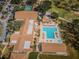 Aerial view of the clubhouse and pool, featuring ample seating, mature landscaping, and a relaxing environment for residents at 2731 Sherbrooke Ln # D, Palm Harbor, FL 34684