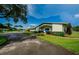 Community clubhouse with tidy landscaping, palm trees, and convenient parking at 2731 Sherbrooke Ln # D, Palm Harbor, FL 34684