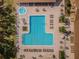 Aerial shot of an inviting community pool featuring a spa, plenty of lounge chairs, and well-maintained landscaping at 2731 Sherbrooke Ln # D, Palm Harbor, FL 34684