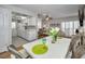 Cozy dining area showcasing a white table with seating and a glimpse into the kitchen at 2731 Sherbrooke Ln # D, Palm Harbor, FL 34684