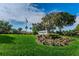 Well manicured landscape and community sign at Highland Lakes Club at 2731 Sherbrooke Ln # D, Palm Harbor, FL 34684