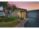 Charming home features lush landscaping, mature palms, and a welcoming entrance at 2731 Sherbrooke Ln # D, Palm Harbor, FL 34684