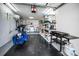 Well-lit garage with laundry area, storage shelves, and ample space for a motorcycle at 2731 Sherbrooke Ln # D, Palm Harbor, FL 34684