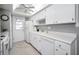 Bright kitchen features white cabinets and appliances at 2731 Sherbrooke Ln # D, Palm Harbor, FL 34684