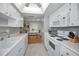 Classic white kitchen featuring appliances and a view into the dining area at 2731 Sherbrooke Ln # D, Palm Harbor, FL 34684