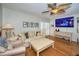 Inviting living room features hardwood floors, sofa, and large screen television at 2731 Sherbrooke Ln # D, Palm Harbor, FL 34684