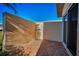Private patio area with tile flooring and stucco wall, perfect for outdoor relaxing at 2731 Sherbrooke Ln # D, Palm Harbor, FL 34684