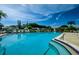 Spacious community pool with lounge chairs and lush tropical landscaping at 2731 Sherbrooke Ln # D, Palm Harbor, FL 34684