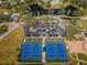 Aerial shot of well-maintained tennis courts with neatly arranged parking, offering an active lifestyle in the community at 2731 Sherbrooke Ln # D, Palm Harbor, FL 34684