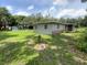 Wide shot of backyard with house, shed and manicured lawn at 3223 Coats Rd, Zephyrhills, FL 33541