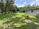 Lush green backyard with large trees offering ample shade at 3223 Coats Rd, Zephyrhills, FL 33541