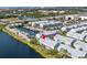 Aerial view of waterfront condominiums featuring boat slips, and landscaping near a highway and urban scenery at 3226 Nautical S Pl, St Petersburg, FL 33712