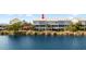 Back exterior of waterfront condo featuring screened patio, beautiful view of the lake and scenic vegetation at 3226 Nautical S Pl, St Petersburg, FL 33712