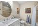 Charming bathroom featuring a vanity sink, decorative art, and tiled shower at 3226 Nautical S Pl, St Petersburg, FL 33712