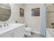 Bright bathroom with a white vanity, decorative art and a tub and shower combination at 3226 Nautical S Pl, St Petersburg, FL 33712