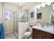 Bright bathroom featuring a glass shower enclosure, vanity with sink, and decorative wall art at 3226 Nautical S Pl, St Petersburg, FL 33712