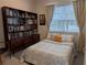 Bedroom featuring a queen bed, large bookshelf and a window offering plenty of natural light at 3226 Nautical S Pl, St Petersburg, FL 33712