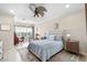 Comfortable bedroom boasts a tufted headboard, area rug, and scenic view from the window at 3226 Nautical S Pl, St Petersburg, FL 33712