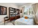 Comfortable bedroom featuring a bookcase, neutral tones, and ample natural light from the window at 3226 Nautical S Pl, St Petersburg, FL 33712