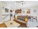 Bright living room and dining area with an open floor plan, modern ceiling fan, and staircase to the upper level at 3226 Nautical S Pl, St Petersburg, FL 33712