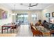 Open-concept living room with a view of the lake, dining area and stylish furnishings at 3226 Nautical S Pl, St Petersburg, FL 33712