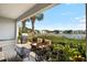 Relaxing patio area with outdoor seating, grill, and a serene lake view at 3226 Nautical S Pl, St Petersburg, FL 33712