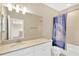 Clean bathroom with a spacious countertop, ample lighting, and a stylish shower curtain at 4071 Balcony Breeze Dr, Land O Lakes, FL 34638