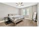 Serene bedroom with a ceiling fan, hardwood floors, large windows, and a calming gray color palette at 4071 Balcony Breeze Dr, Land O Lakes, FL 34638