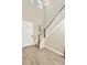 Bright foyer featuring wood flooring, a white front door, staircase with wooden banister and white risers, and a high ceiling at 4071 Balcony Breeze Dr, Land O Lakes, FL 34638