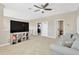 Spacious living room with a large television, open shelving, and comfortable seating, perfect for relaxation at 4071 Balcony Breeze Dr, Land O Lakes, FL 34638
