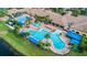 Aerial view of community pools, clubhouse, and lush landscaping at 4946 Sapphire Sound Dr, Wimauma, FL 33598