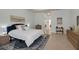 Comfortable bedroom features neutral decor, a large bed, and modern furnishings at 4946 Sapphire Sound Dr, Wimauma, FL 33598