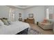 Bright primary bedroom featuring tray ceiling, shuttered windows, and sitting area at 4946 Sapphire Sound Dr, Wimauma, FL 33598