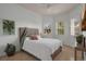 Bedroom with a white duvet, decorative pillows, and sun-filled windows at 4946 Sapphire Sound Dr, Wimauma, FL 33598
