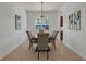 Formal dining room features modern light fixture, window, and elegant decor at 4946 Sapphire Sound Dr, Wimauma, FL 33598