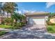 Beautiful home showcasing a two-car garage, paver driveway, and manicured landscaping at 4946 Sapphire Sound Dr, Wimauma, FL 33598