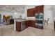 Open concept kitchen with stainless appliances, granite counters, and seamless living room access at 4946 Sapphire Sound Dr, Wimauma, FL 33598