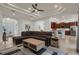 Spacious living room with tray ceilings, modern lighting, and seamless flow to the kitchen at 4946 Sapphire Sound Dr, Wimauma, FL 33598