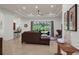 Bright living room features tile flooring, a ceiling fan, and a view of the backyard at 4946 Sapphire Sound Dr, Wimauma, FL 33598