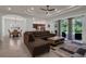 Stylish living room with dining area, tile flooring, and expansive windows overlooking the outdoor space at 4946 Sapphire Sound Dr, Wimauma, FL 33598